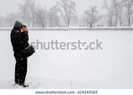 Man is making a picture of snowy trees