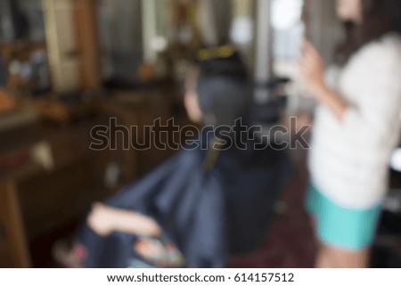 Blurred of Woman in hair salon doing her hair style.