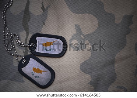 army blank, dog tag with flag of cyprus on the khaki texture background. military concept