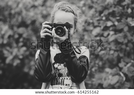 teen girl taking a shoot with old photo camera