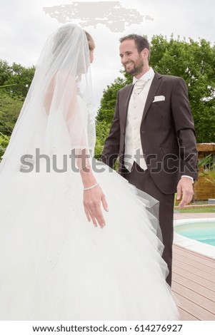 Happy Married couple near a swimming pool