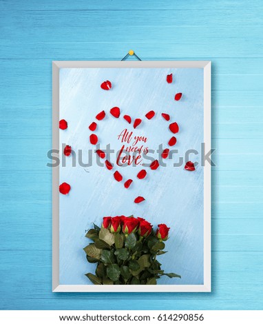 Heart of red rose petals on blue painted rustic background. All you need is love. Valentines day or love concept. Fresh natural bouquet of flowers. Photo frame on wooden rustic wall.
