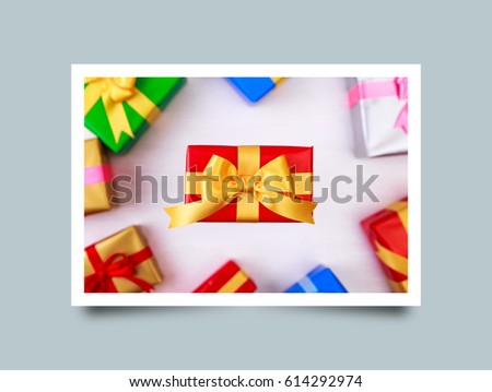 Gift boxes with bow. Colored presents wrapped with paper and ribbons. Christmas or birthday packages. Celebration design. On white table. Photo frame design with shadow.