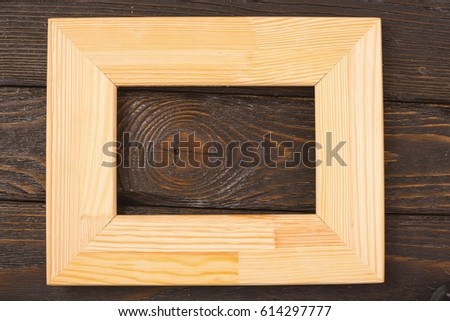 Light wooden photo frame on wooden boards