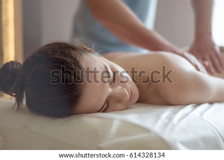Body care. Spa body massage treatment. Woman having massage in the spa salon. Royalty-Free Stock Photo #614328134