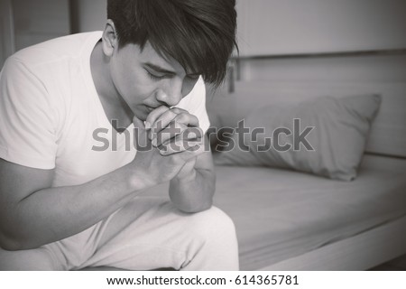 Portrait of Asian man expression in depression (man, sad, praying)
