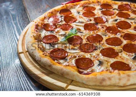Italian pizza salami-peperoni. Macro (A series of different types of pizza for menus photographed from one angle) Royalty-Free Stock Photo #614369108
