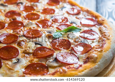 Italian pizza salami-peperoni. Macro (A series of different types of pizza for menus photographed from one angle) Royalty-Free Stock Photo #614369120