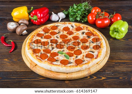 Italian pizza salami-peperoni. View 45 degrees (A series of different types of pizza for menus photographed from one angle) Royalty-Free Stock Photo #614369147