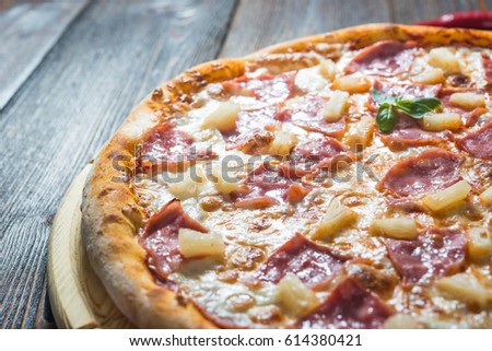Italian pizza with ham and pineapple. Macro (A series of different types of pizza for menus photographed from one angle) Royalty-Free Stock Photo #614380421