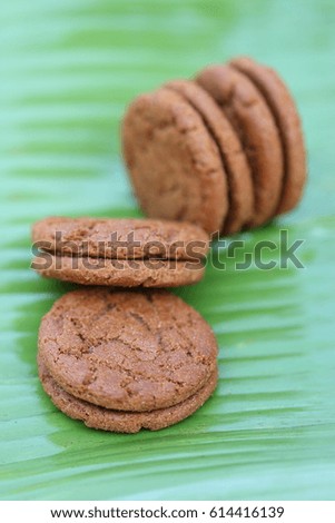 Brown sandwich cookies on green banana leaves, healthy eat concept