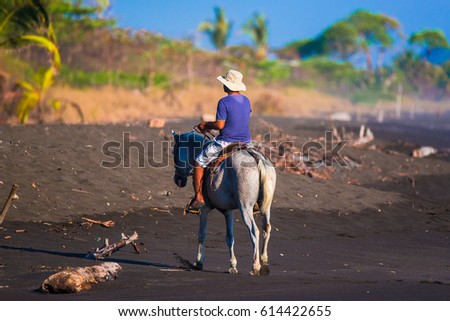 Man on horseback on the beach. Costa Rica, natural paradise