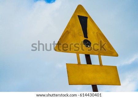 exclamation yellow road sign on sky with clouds  background. empty yellow sign 