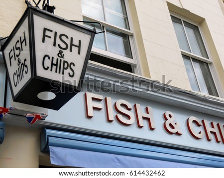 Vintage Fish and Chips sign outside a restaurant in London, England Royalty-Free Stock Photo #614432462