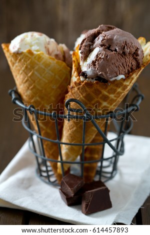 chocolate and vanilla ice cream in waffle cones