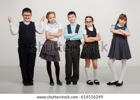 A group of children in uniforms in the Studio on a white background. Education, fashion, the concept of friendship.