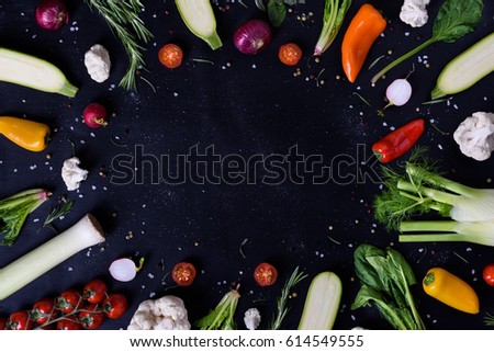 Selection of healthy vegetables and spices, veggie frame, black background. Top view, copy space.