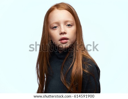 Little girl shy herself, girl in dark clothes, light background
