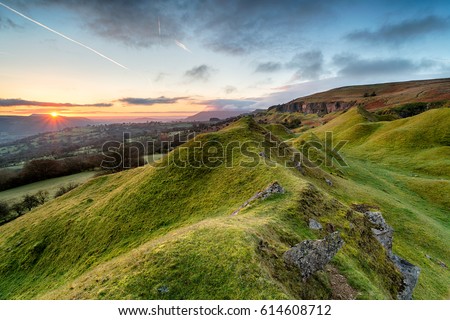 Beautiful sunrise over the Llangattock Escarpment in the Brecon Beacons national park in Wales Royalty-Free Stock Photo #614608712