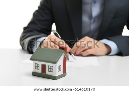 House model and blurred man on background. Insurance concept