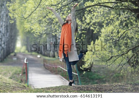 happy young woman jumping in the spring forest