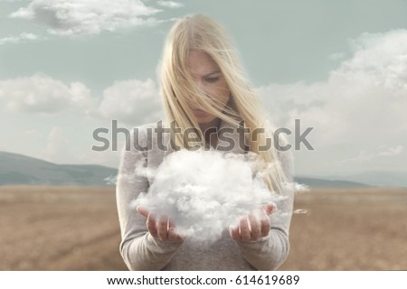 surreal moment , woman holding in her hands a soft cloud Royalty-Free Stock Photo #614619689