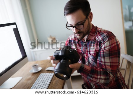 Photographer retoucher working on photos and editing on desktop