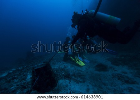 Scuba diver swim through coral reef, Malapascua.