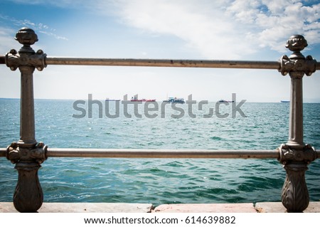 Greece, Thessaloniki, about july 2015, Tankers in harbor, viewed through the bars	 Royalty-Free Stock Photo #614639882