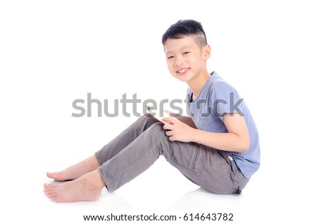 Young asian boy reading book over white background
