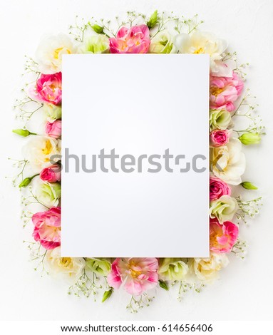 Festive flower concept : beautiful floral border on the white  background with copy space.  Flat lay.
