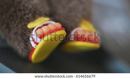 Close up of foot doll bear heart shape. Teddy Bear The picture is clear in the center of the image. Soft focus, vintage style.