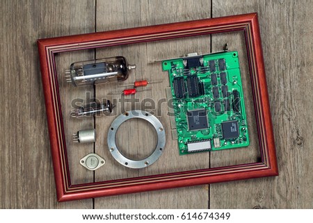 Radio and electronic components in a frame on a wooden table