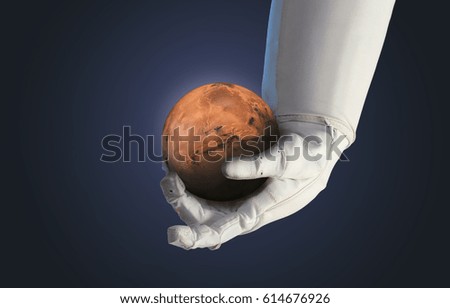 Mars in the hand of astronaut. The Blue Marble. Future and space technology theme. Elements of this image furnished by NASA. 