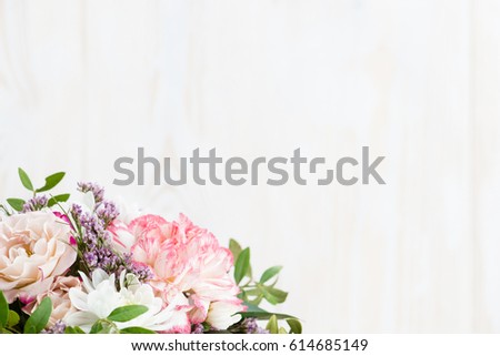Colorful flowers close-up on a white wooden background. Copy space
