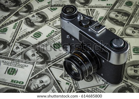 Old Soviet camera on a pile of dollars