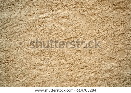 Vibrant yellow beige grungy wall texture background.