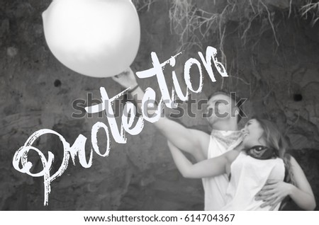 loving couple enjoying the beautiful day, couple in love,hold the inflated condom,soft focus