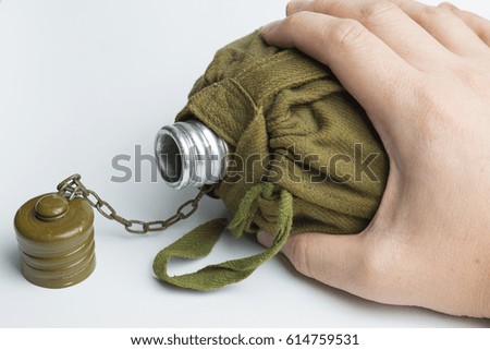 Man holding army water canteen isolated on a white background