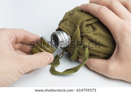 Man holding army water canteen isolated on a white background
