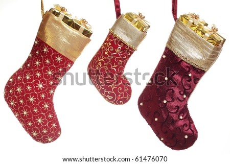 Christmas stocking with gift box hanging over white background.