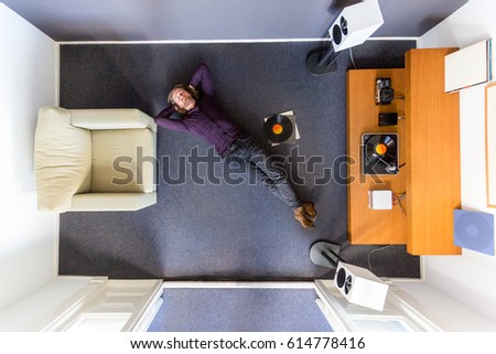 Top view of a man chilling out on the floor listening to music
