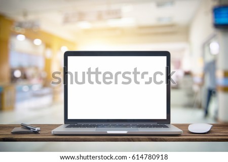 Computer notebook and mouse with Hospital blur Blurred image of patient waiting for see doctor. For background uses. Royalty-Free Stock Photo #614780918