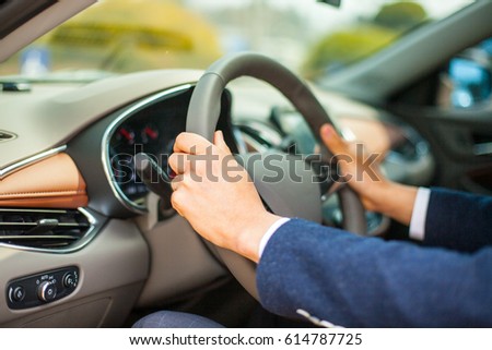 Close-up of a man's hand holding a handle/right attitude of driving/side view of a car driver Royalty-Free Stock Photo #614787725