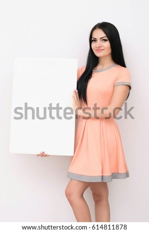 Portrait of smiling business woman with blank white sign board. Isolated studio portrait.