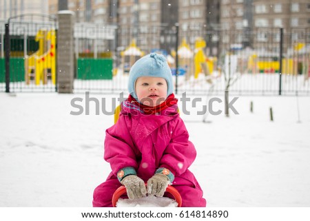 baby winter on the site walks laughing