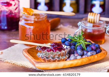 Homemade jam from blueberries and oranges, blueberries on a wooden background
