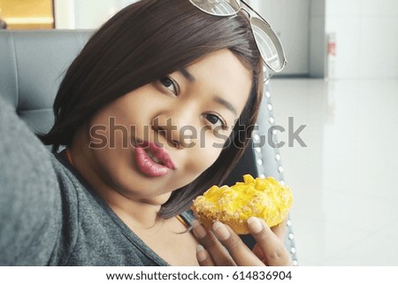 Woman taking a selfie with donut