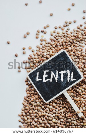 Lentils vegetarian food and chalkborad with word "lentil" on white background