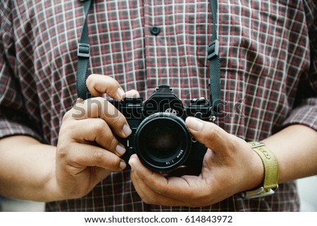 Retro camera in photographer hand vintage tone concept background